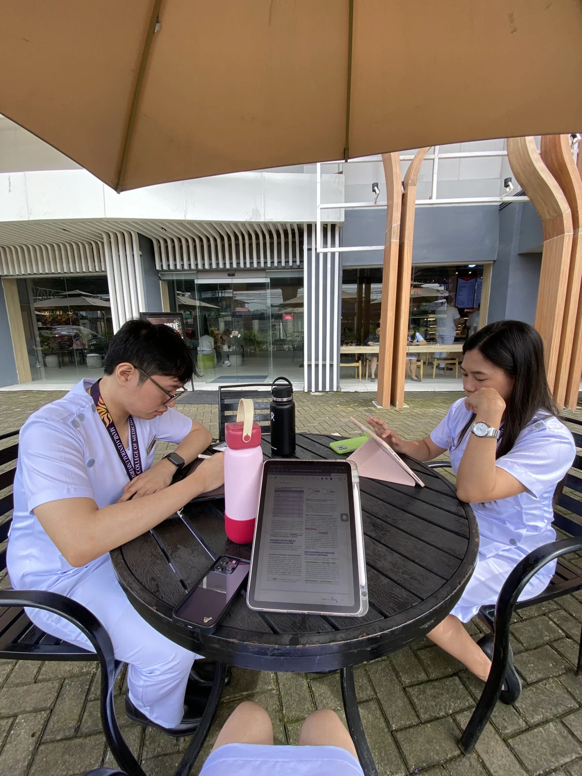 Studying outdoors with my classmates and reviewing our lessons together.