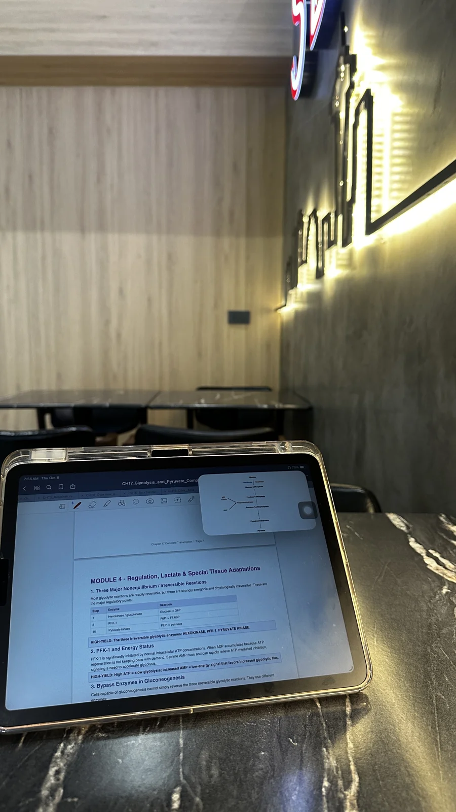 Reviewing glycolysis on my device while studying at SBC.